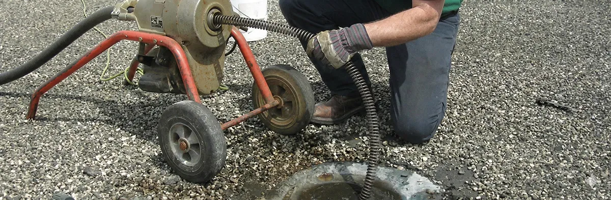 sewer rodding technician actively removing blockages from a sewer line in Baltimore, MD